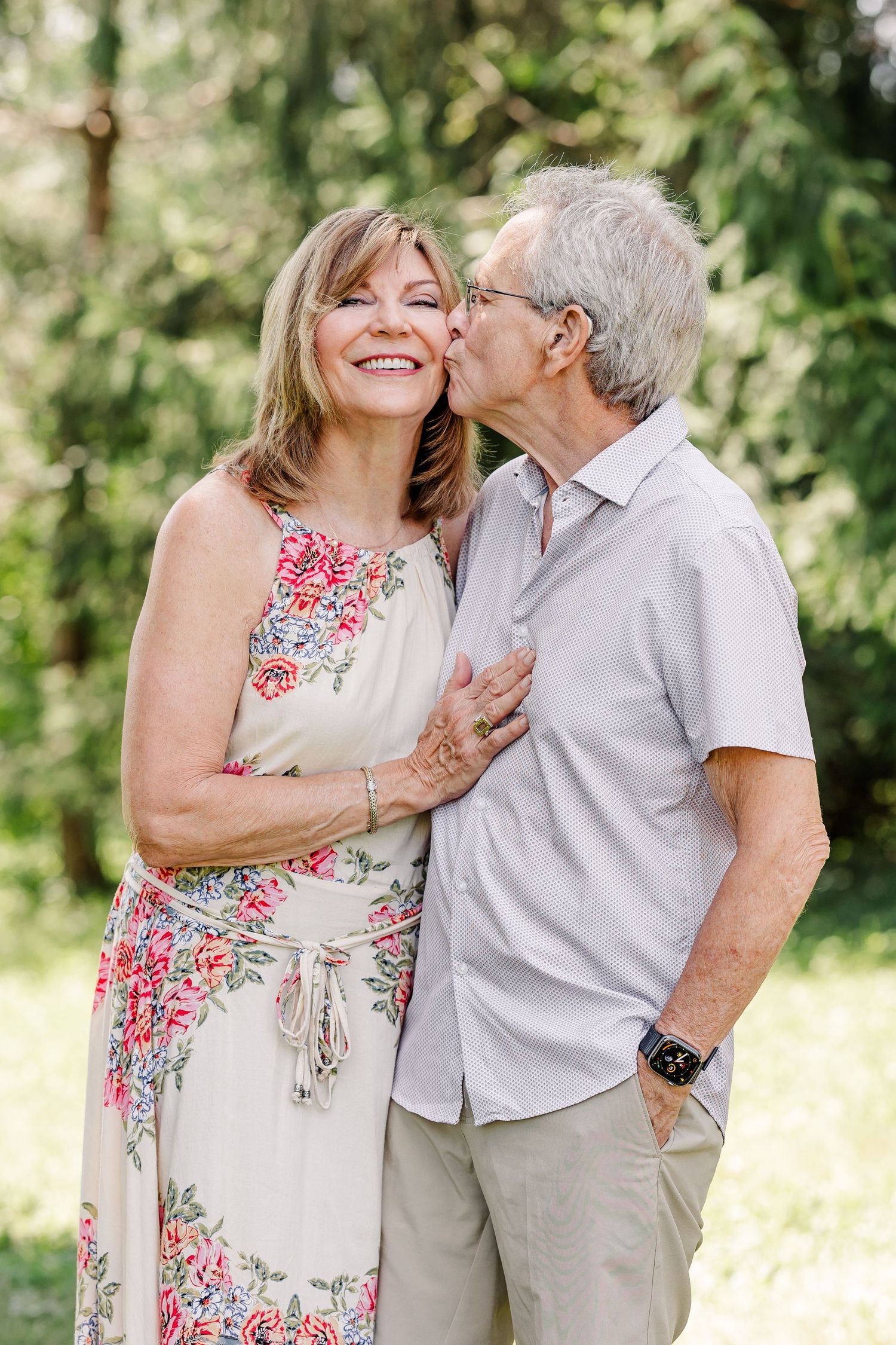 Husband kissing his wife during a sweet summer family portrait session in Crystal Lake, IL.