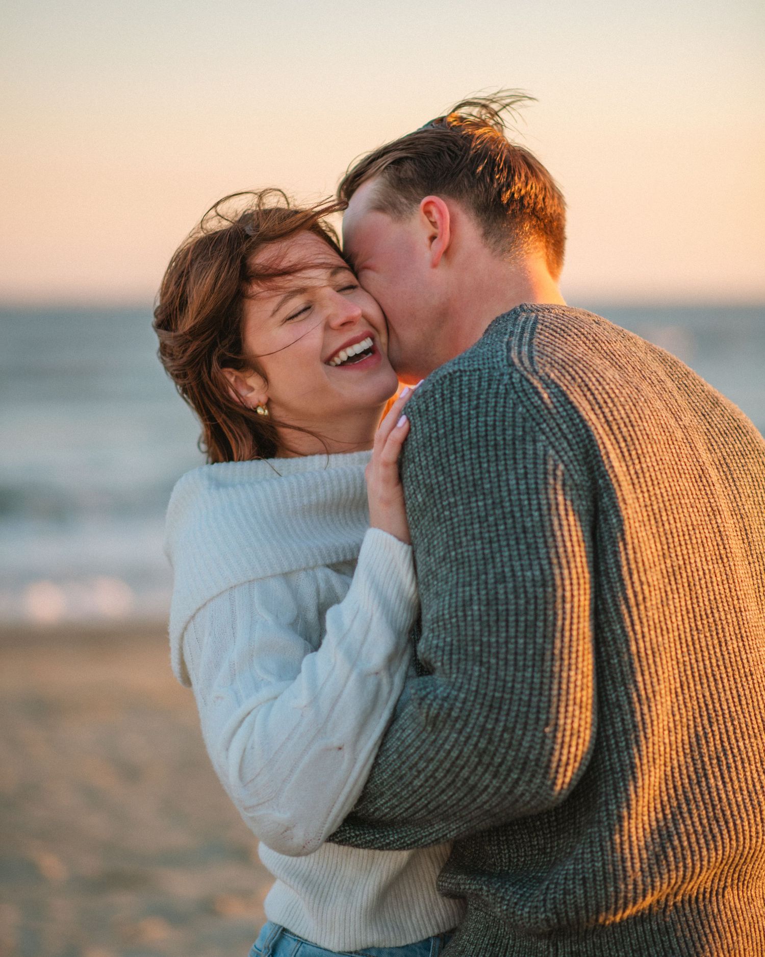 Couple laughing together on the beach during a romantic sunset engagement session.
on Sullivans Island, Charleston SC