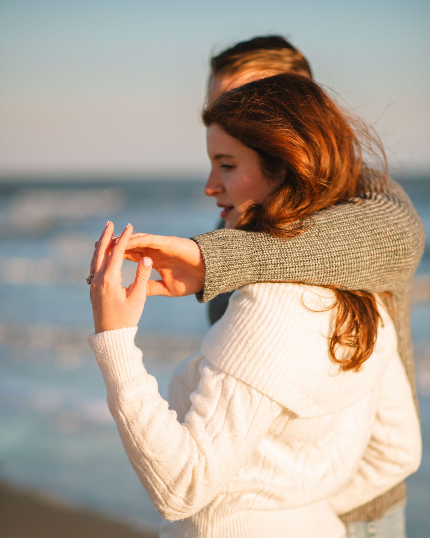 Close-up of couple with engagement ring visible during a romantic beach session. on Sullivans Island, Charleston SC