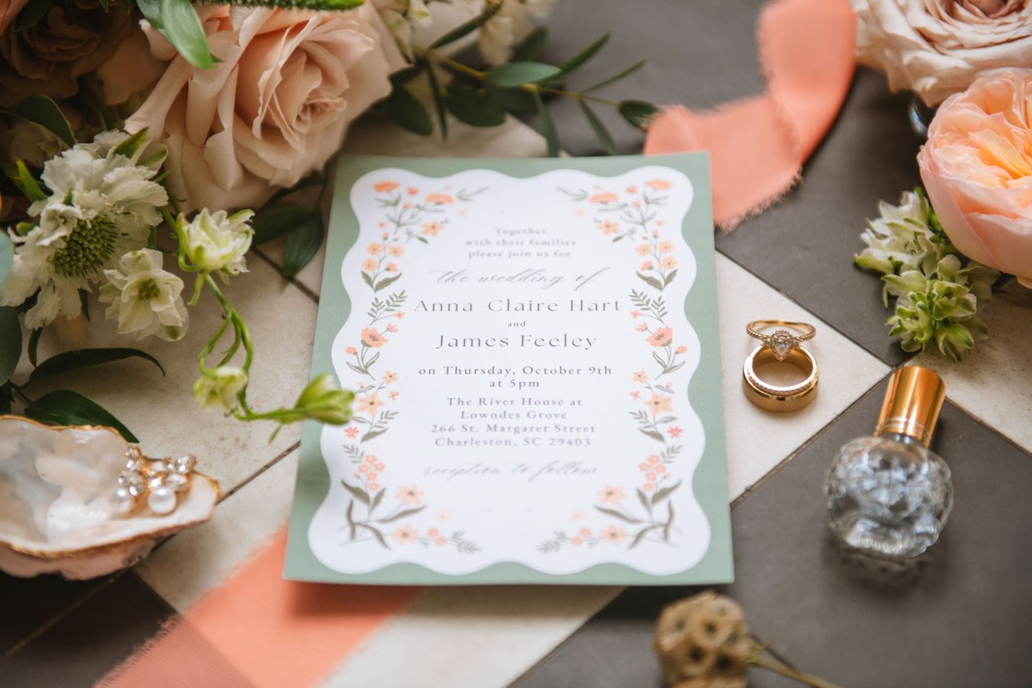 Wedding invitation flat lay with rings, florals, and bridal details styled elegantly. At Lowndes Grove Charleston SC