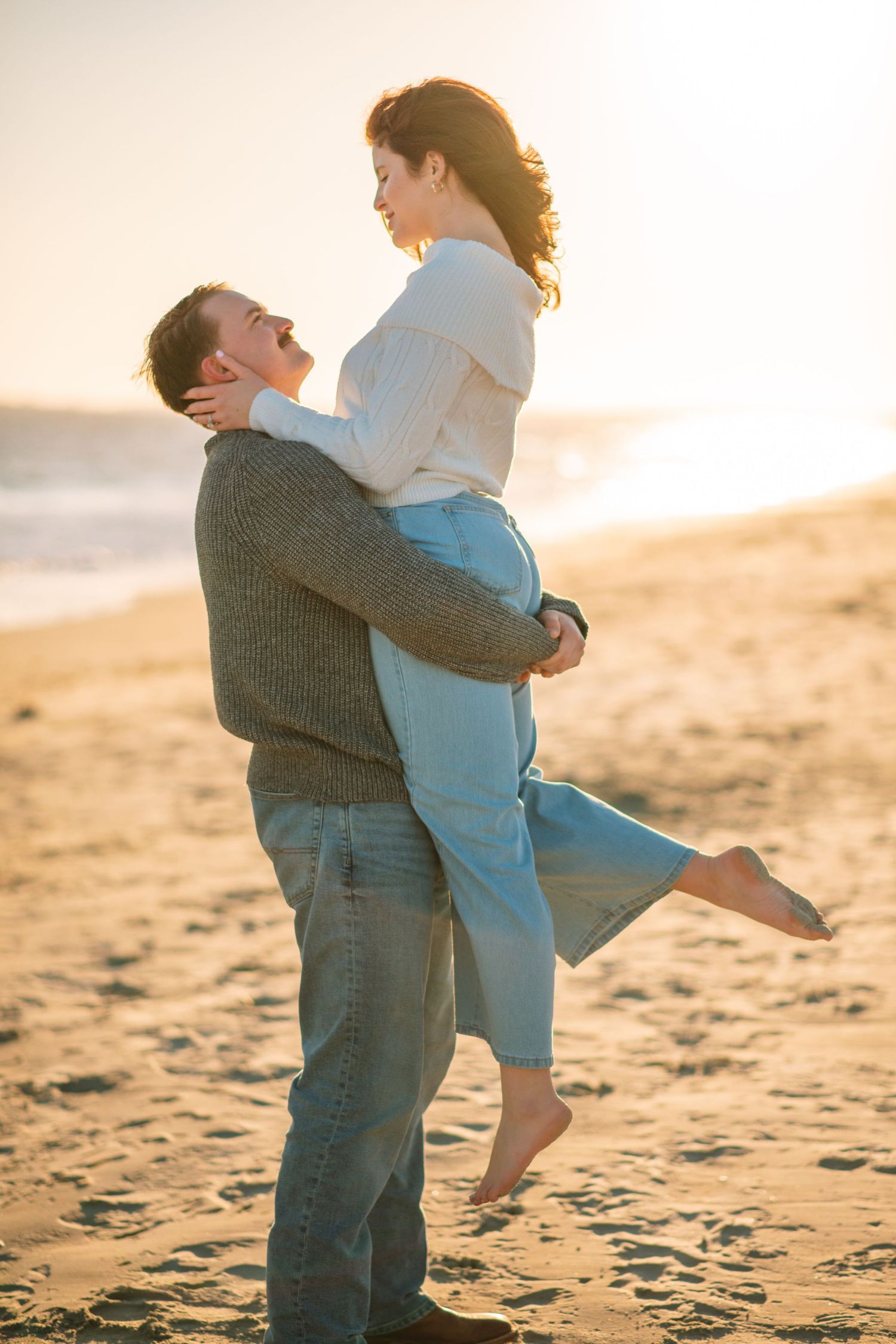 Man lifting woman on beach during a playful and romantic sunset session.
on Sullivans Island, Charleston SC