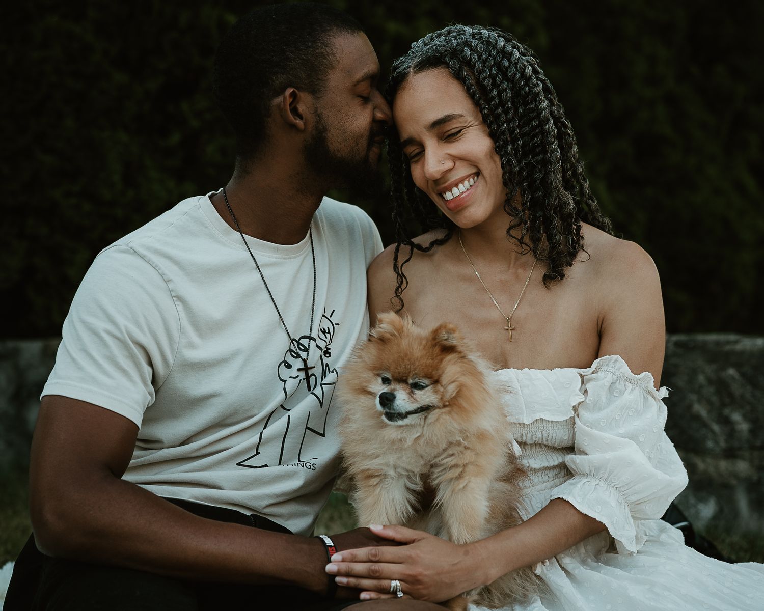 Couple embracing with their Pomeranian outdoors, Connecticut couples photography session