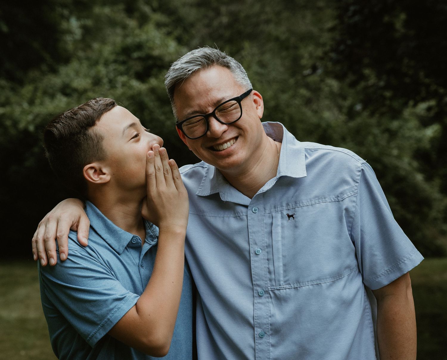 Son sharing a laugh with his father during a Woodbridge CT family portrait session