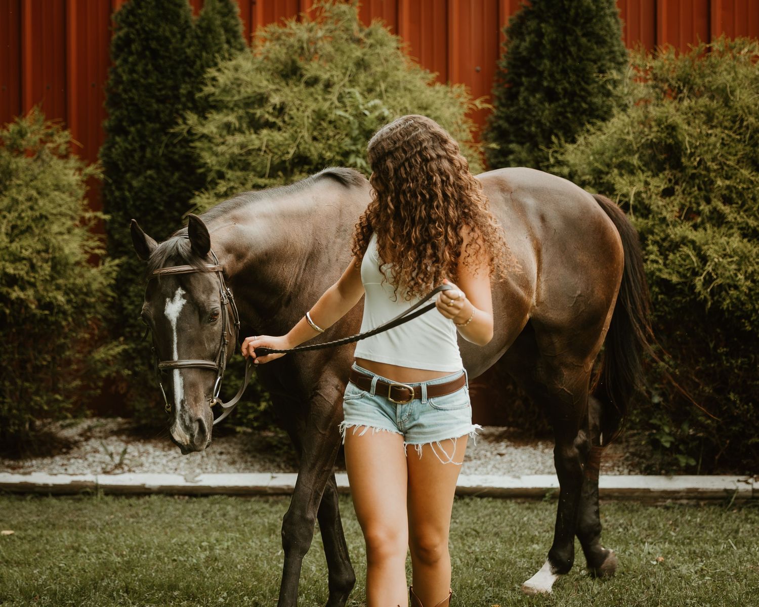 Young rider embracing her horse during an equestrian portrait session in Connecticut.