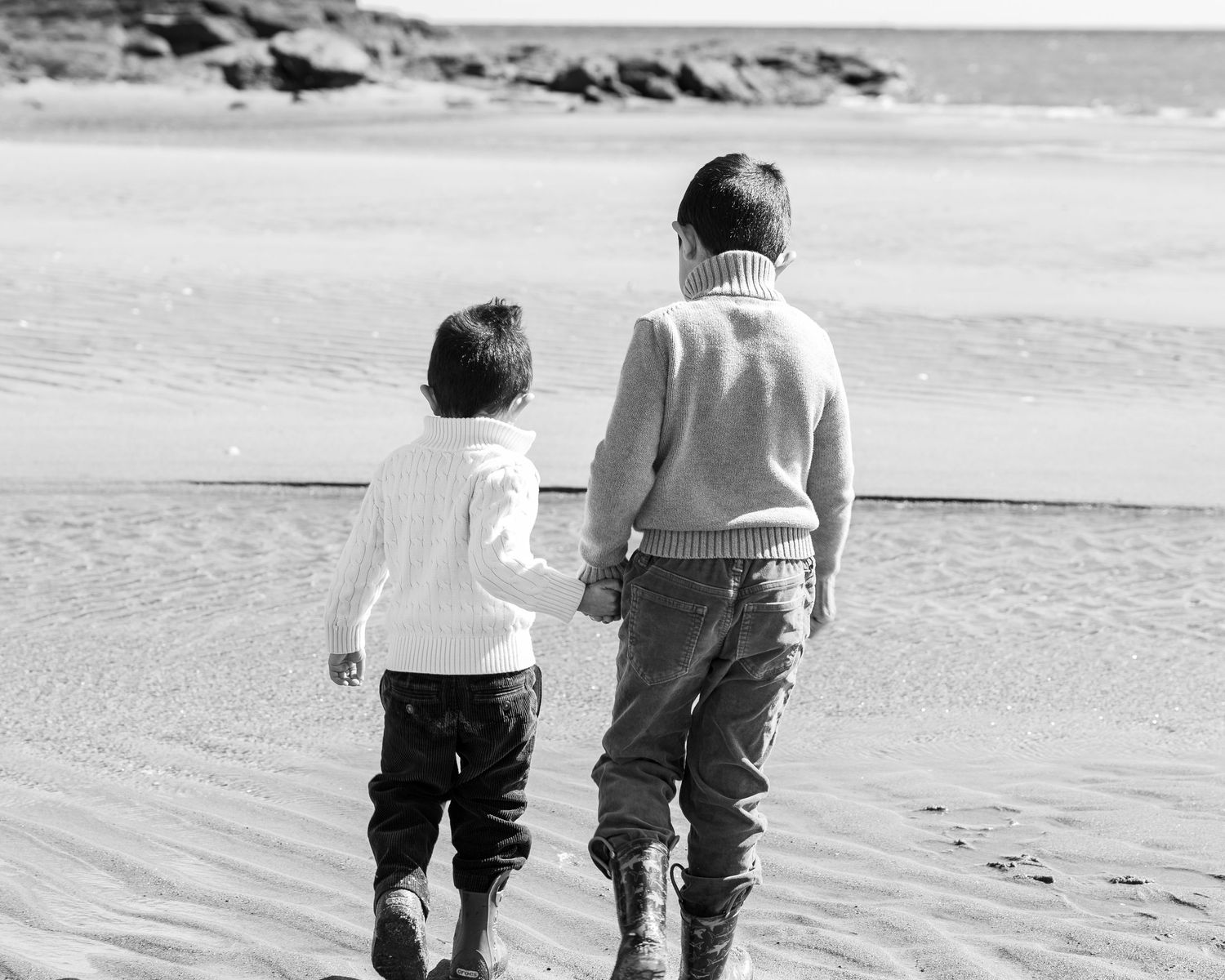 Two boys looking out at the water at Sea Bluff Beach, black and white portrait by Connecticut photographer Noemi Blumenthal