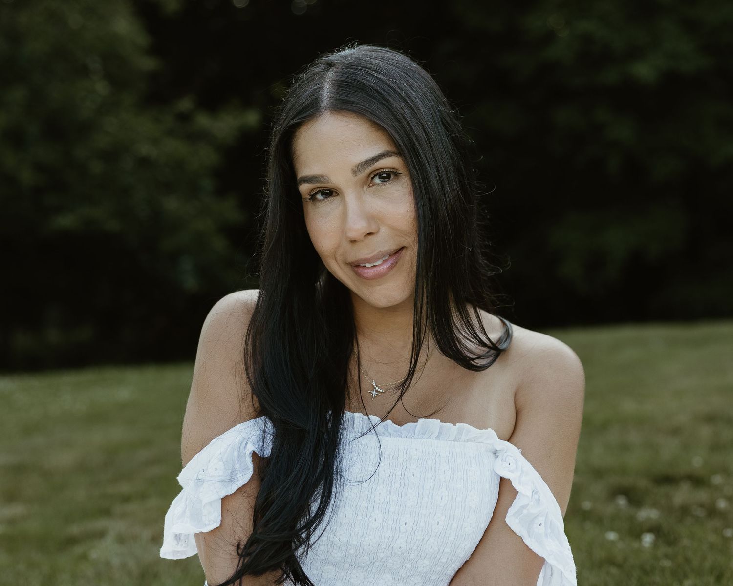Woman in a white off-shoulder top smiling outdoors, portrait photographer Woodbridge CT