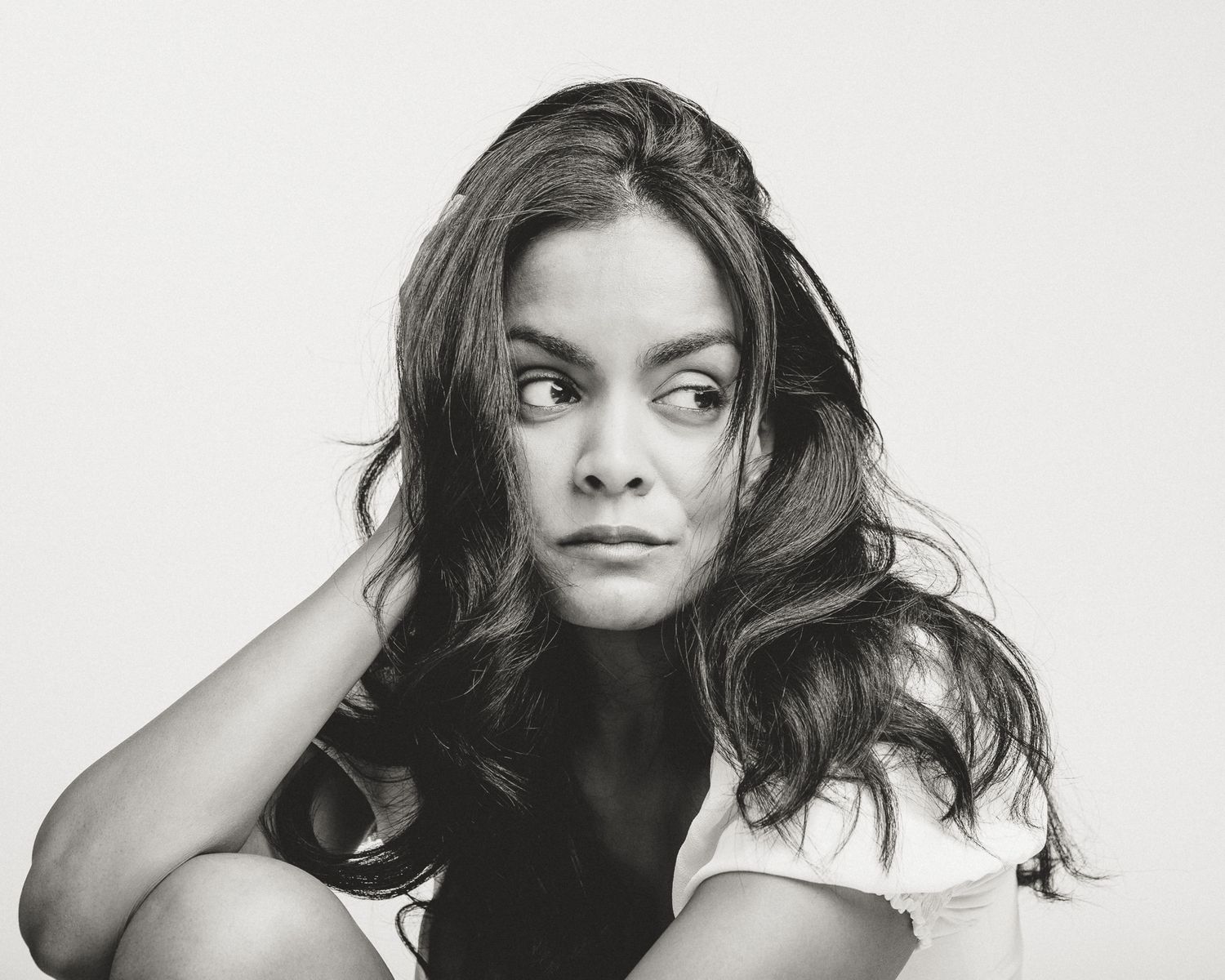 Black and white portrait of woman with tousled hair looking over shoulder, Connecticut photographer