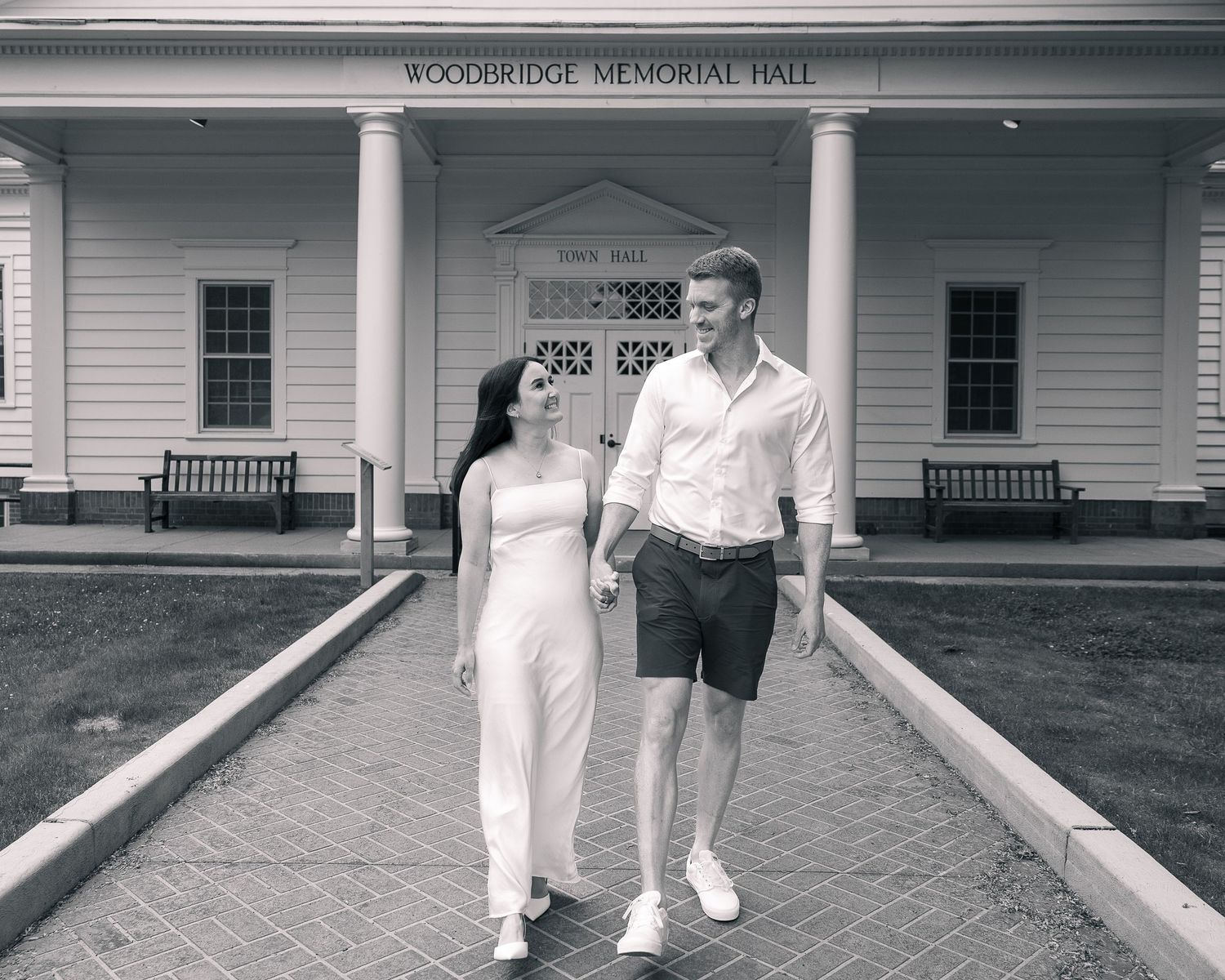 Couple holding hands in front of Woodbridge Memorial Hall, Woodbridge CT portrait photographer