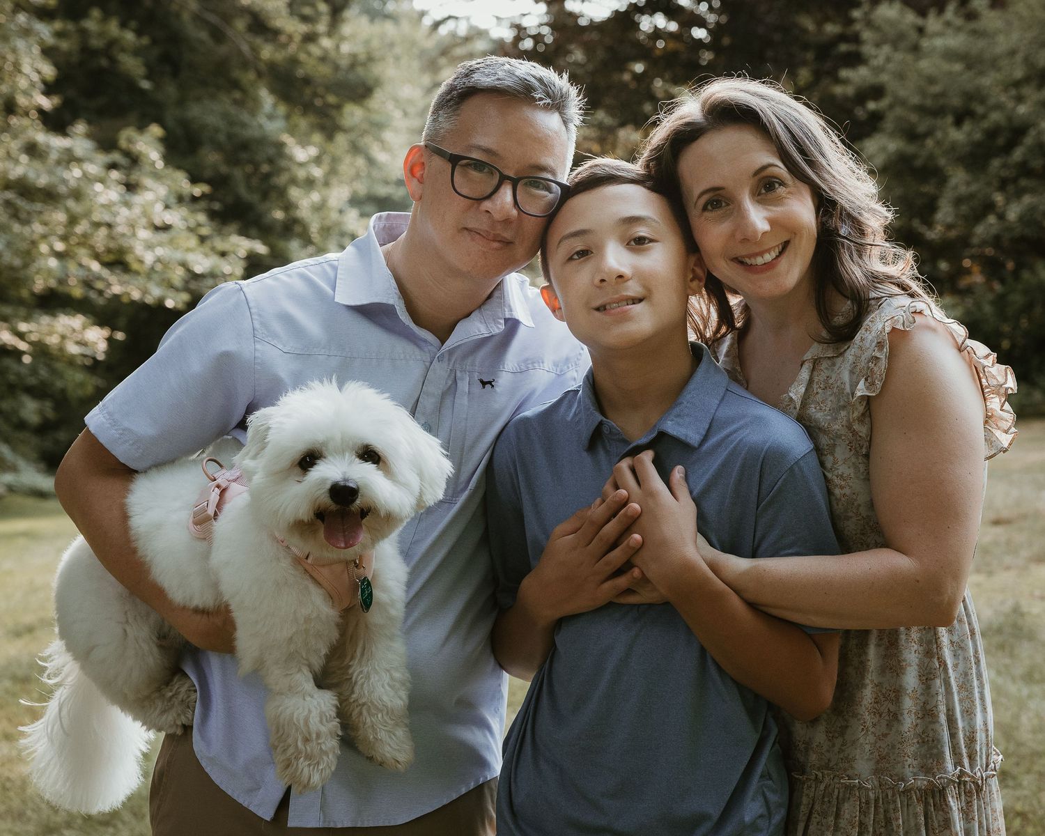 Family photography session in Woodbridge CT featuring a mother, father, teenage son, and their dog outdoors