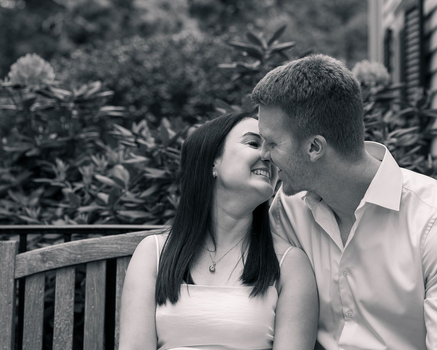 Couple laughing together on bench, New Haven County CT portrait photographer
