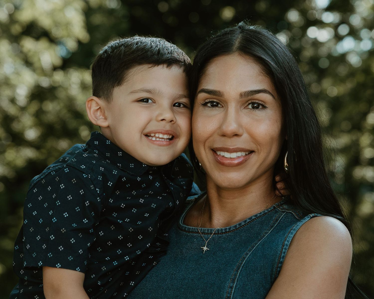 Mother and son cheek to cheek, smiling outdoors during a family photography session in Woodbridge, CT