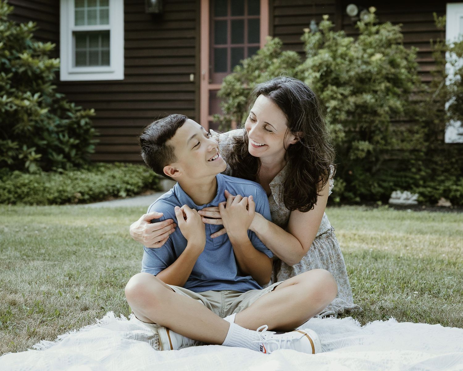 Mother embracing her son on the lawn during a Woodbridge CT family portrait session
