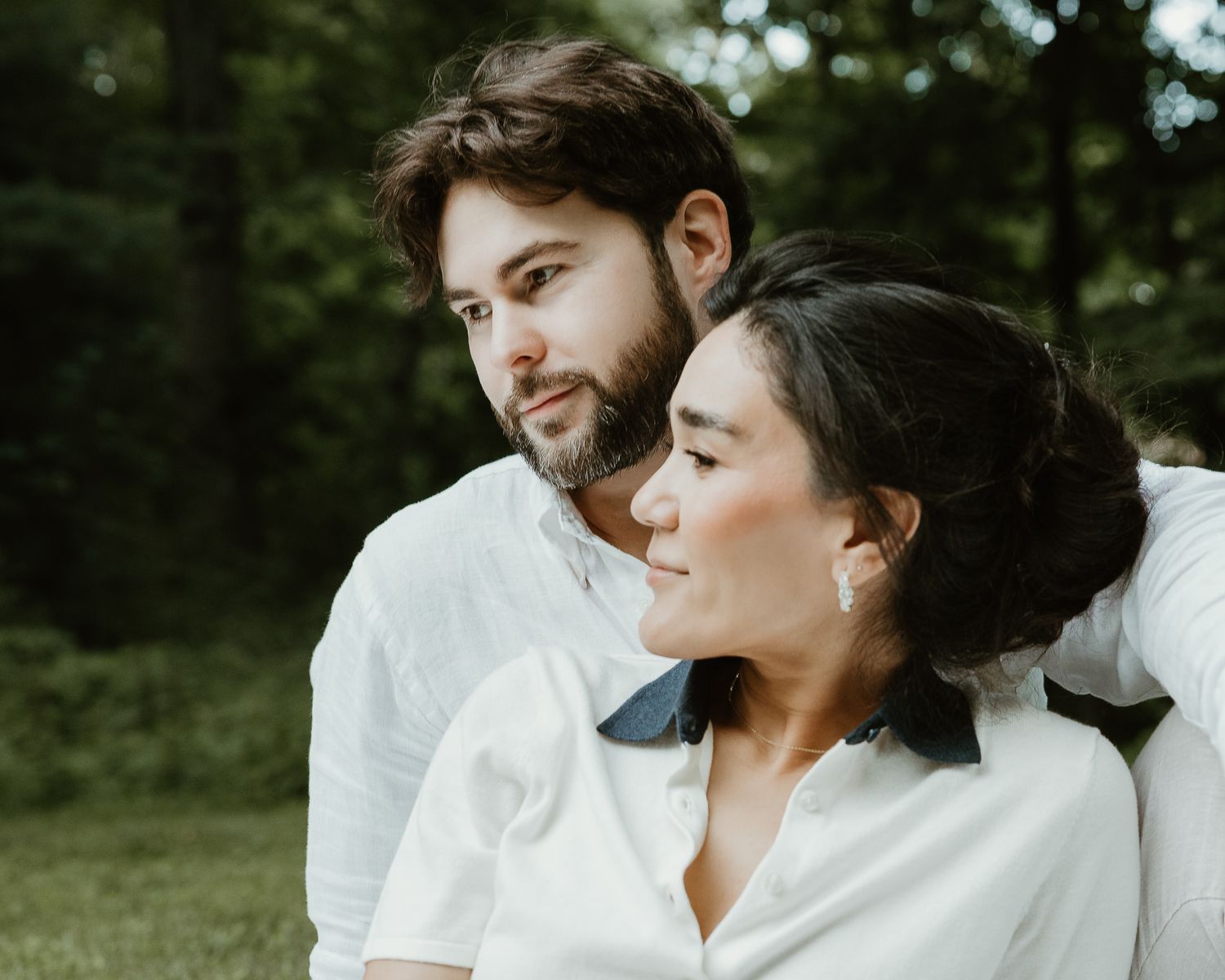 Couple embracing outdoors among trees, natural light portrait session in Woodbridge, CT