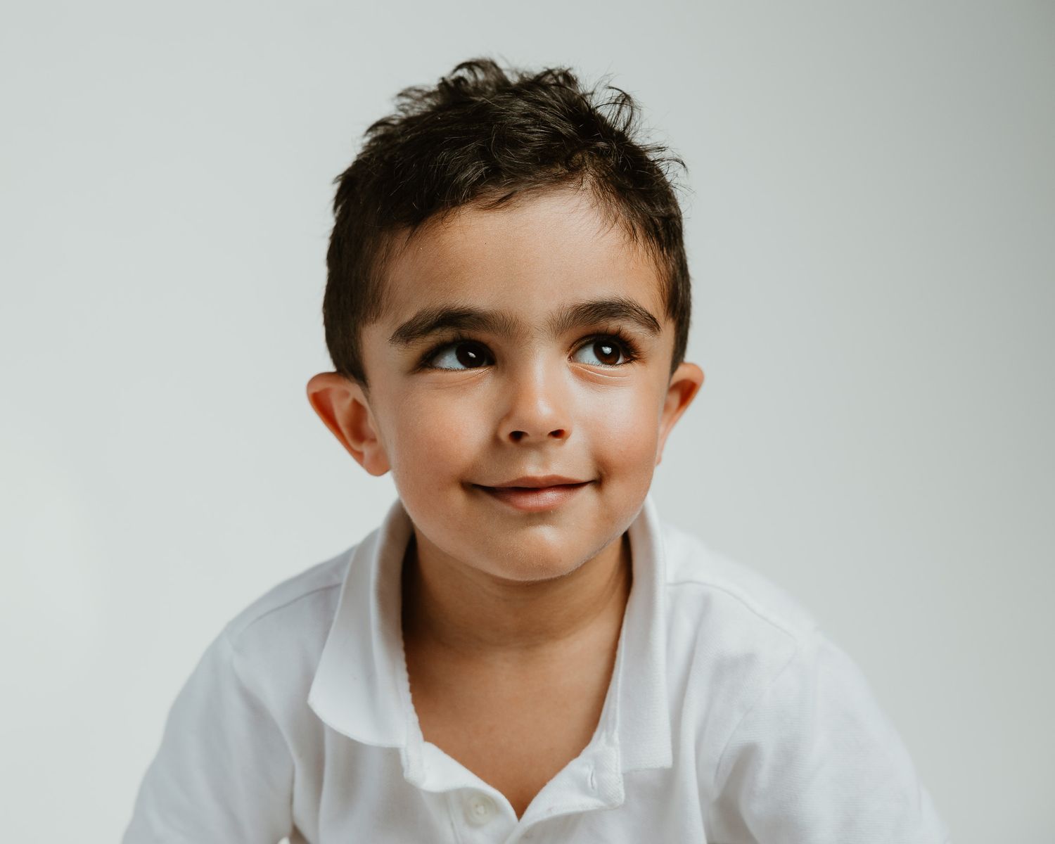 Studio portrait of a boy looking up and smiling, Connecticut children's photography