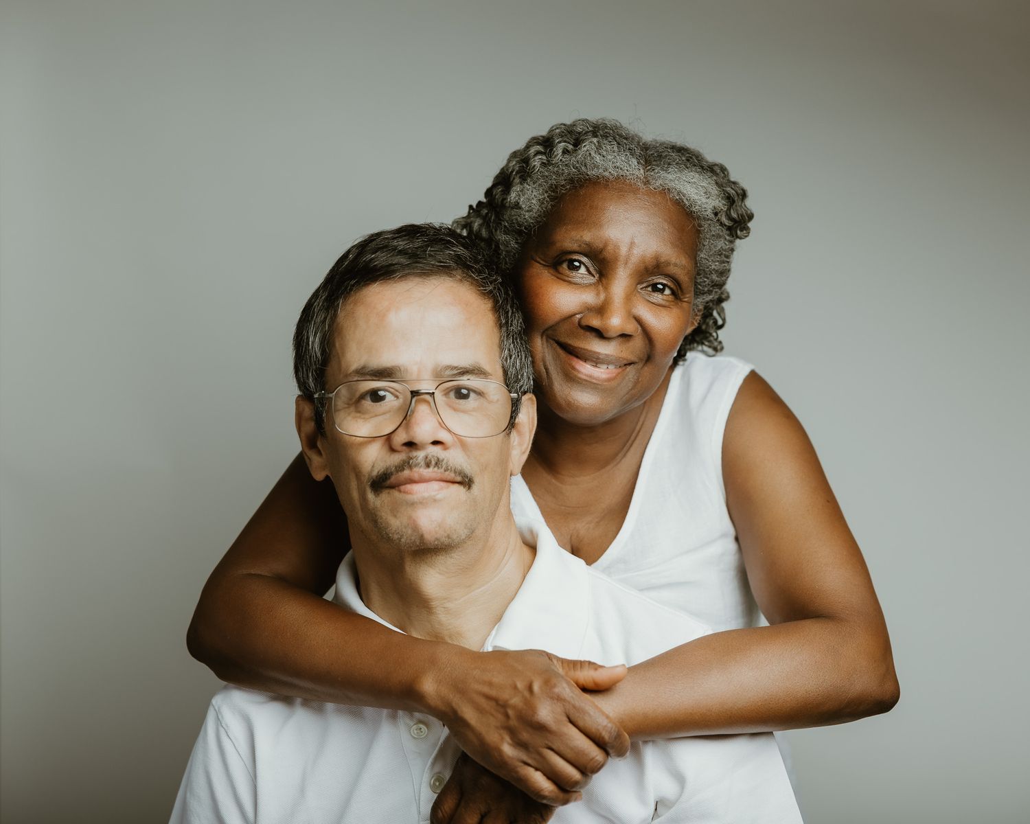 Husband embracing wife from behind in studio portrait, Woodbridge CT photographer