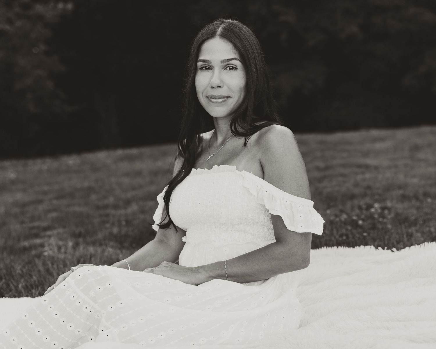 Black and white outdoor portrait of Christina seated on a blanket, editorial femme photography in Connecticut