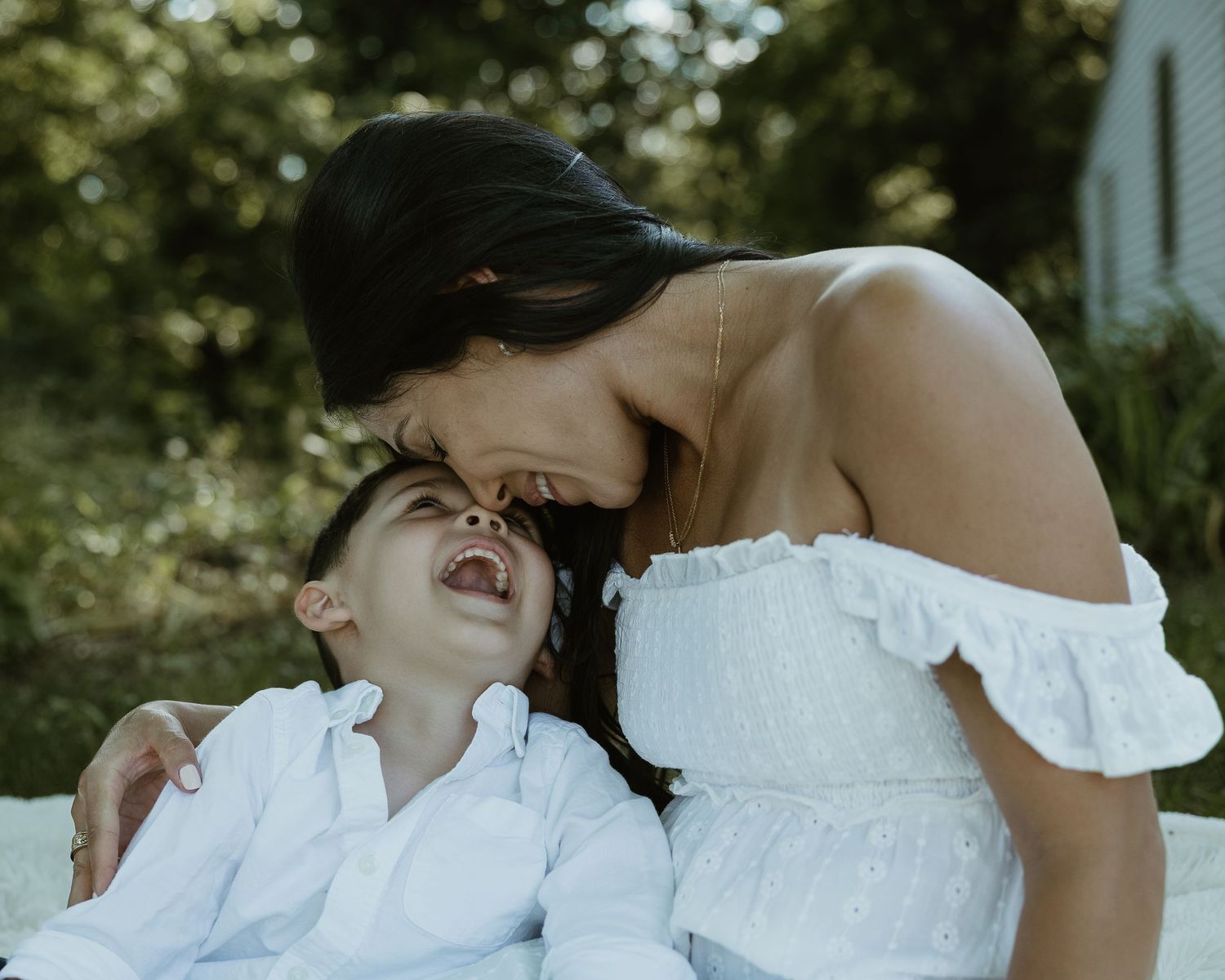 Mother laughing with her son outdoors, Connecticut family photography session