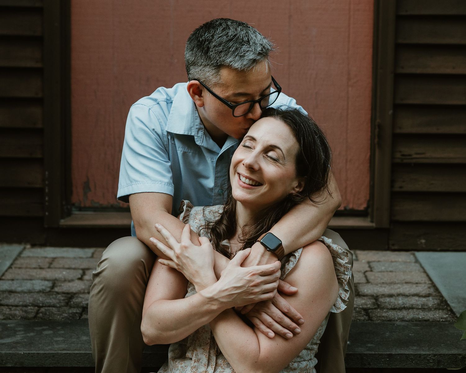 Family portrait photographer in Woodbridge CT capturing a couple embracing on their front porch