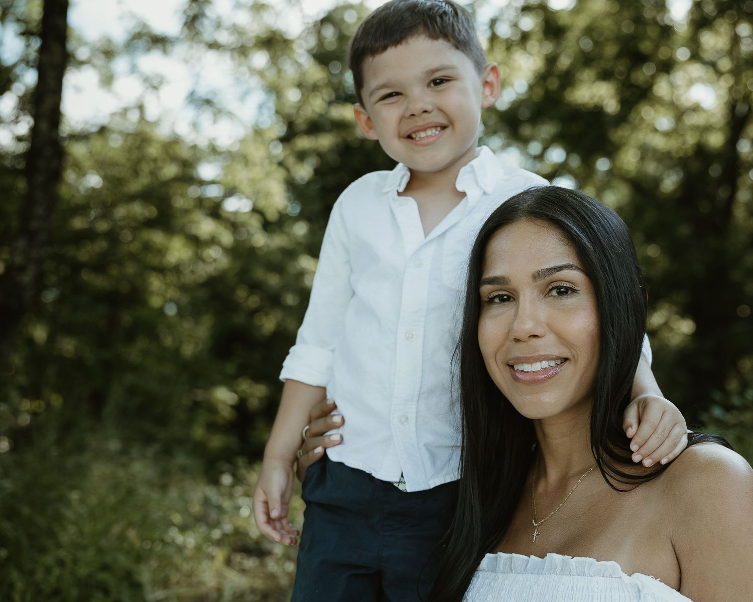 Mother and son in white outfits standing together outdoors, New Haven County CT family portrait