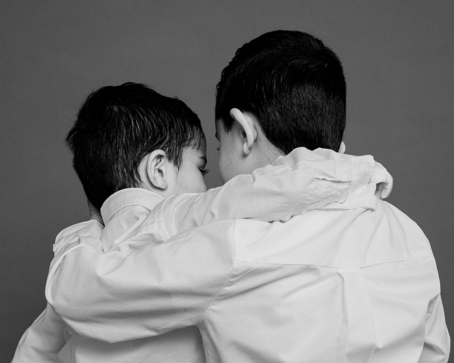Children portrait photography Connecticut, two brothers embracing outdoors black and white