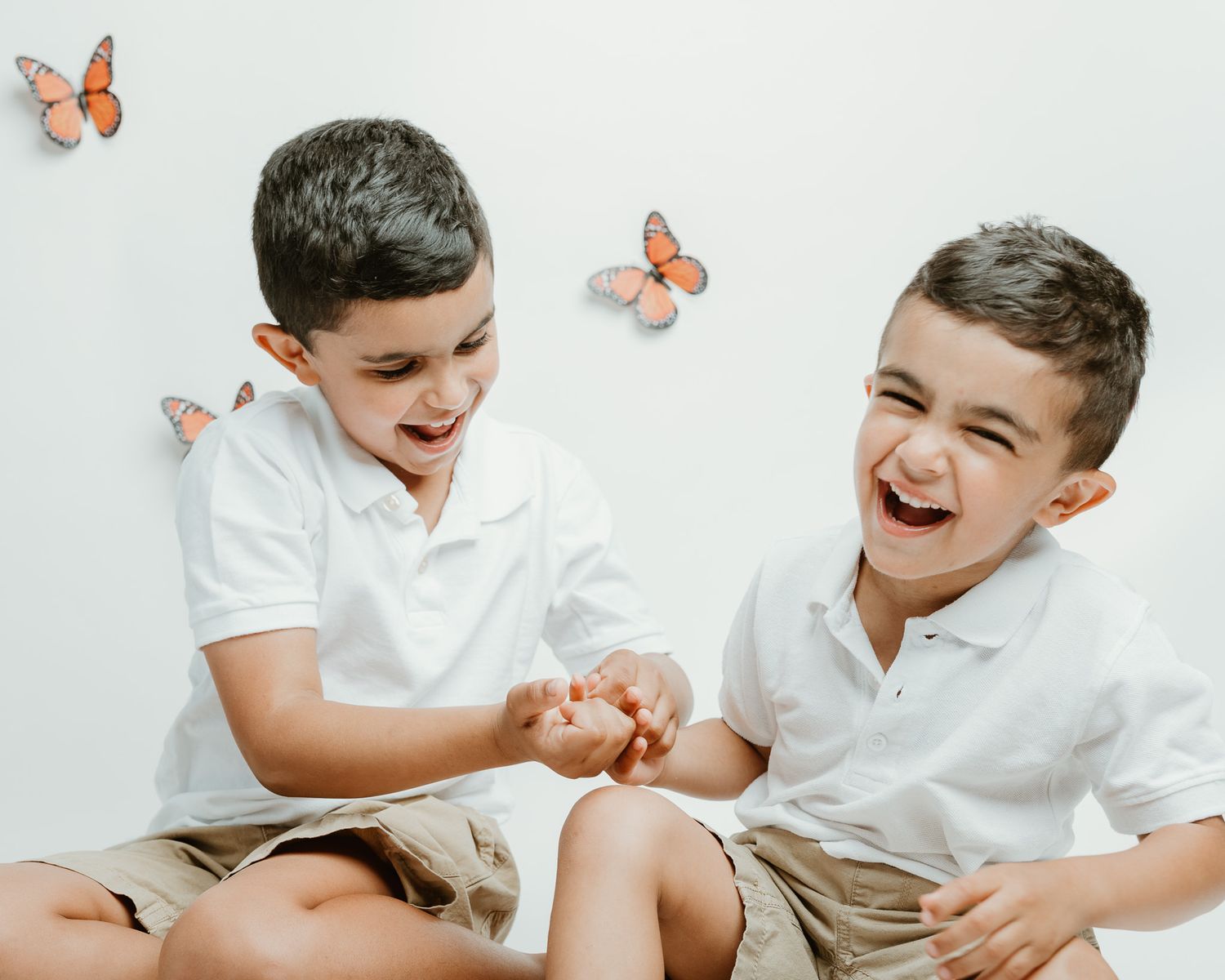 Two brothers laughing together during a studio butterfly session, Connecticut children's photography