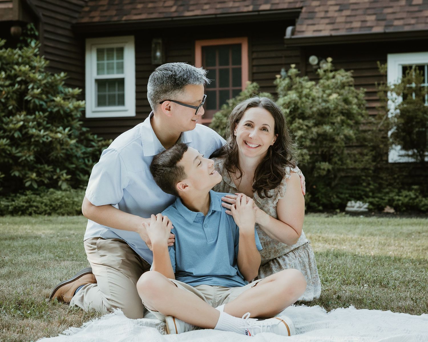 Family portrait photographer in Woodbridge CT capturing a father, mother, and son together