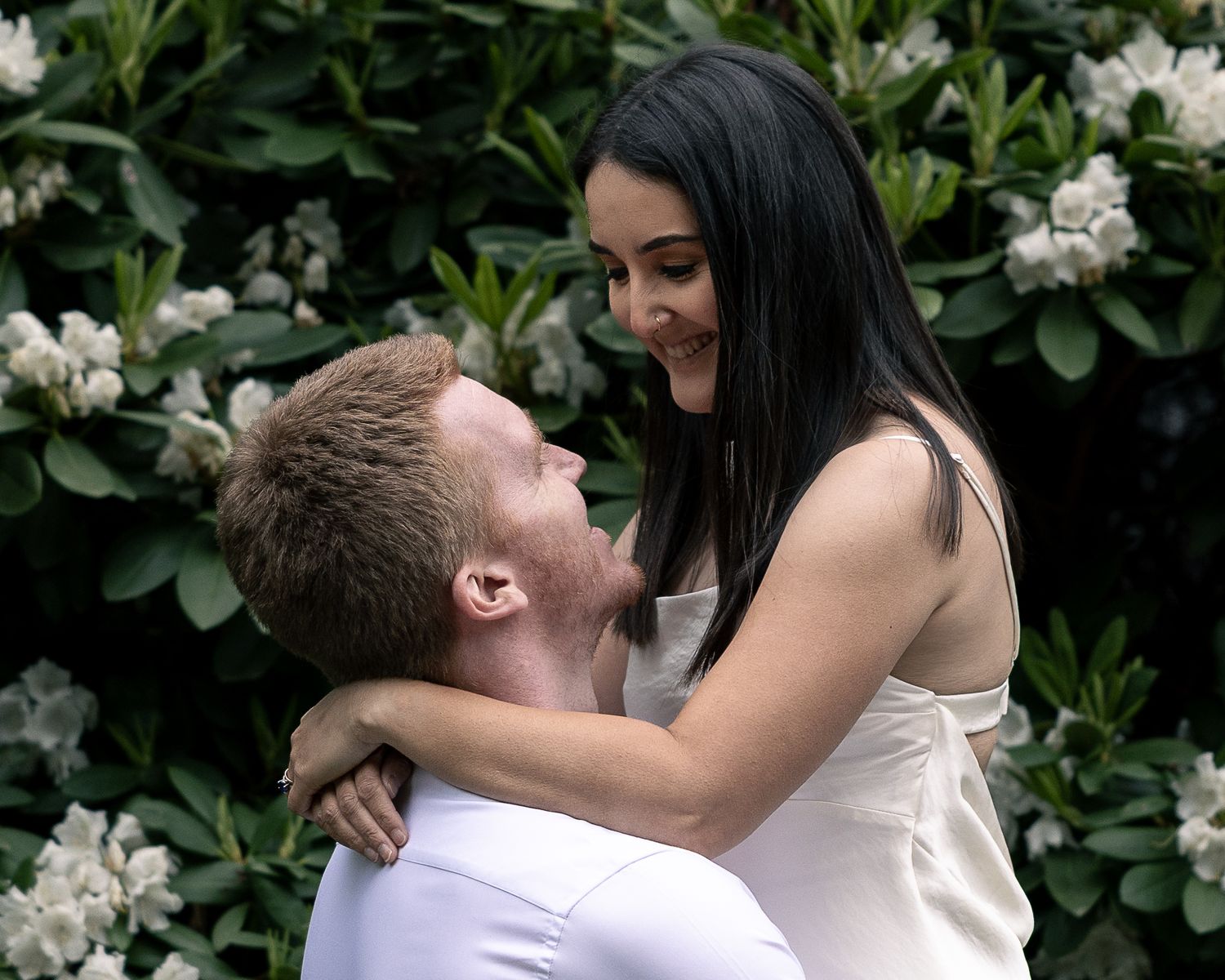 Couple embracing among flowering bushes, Connecticut couples photography session