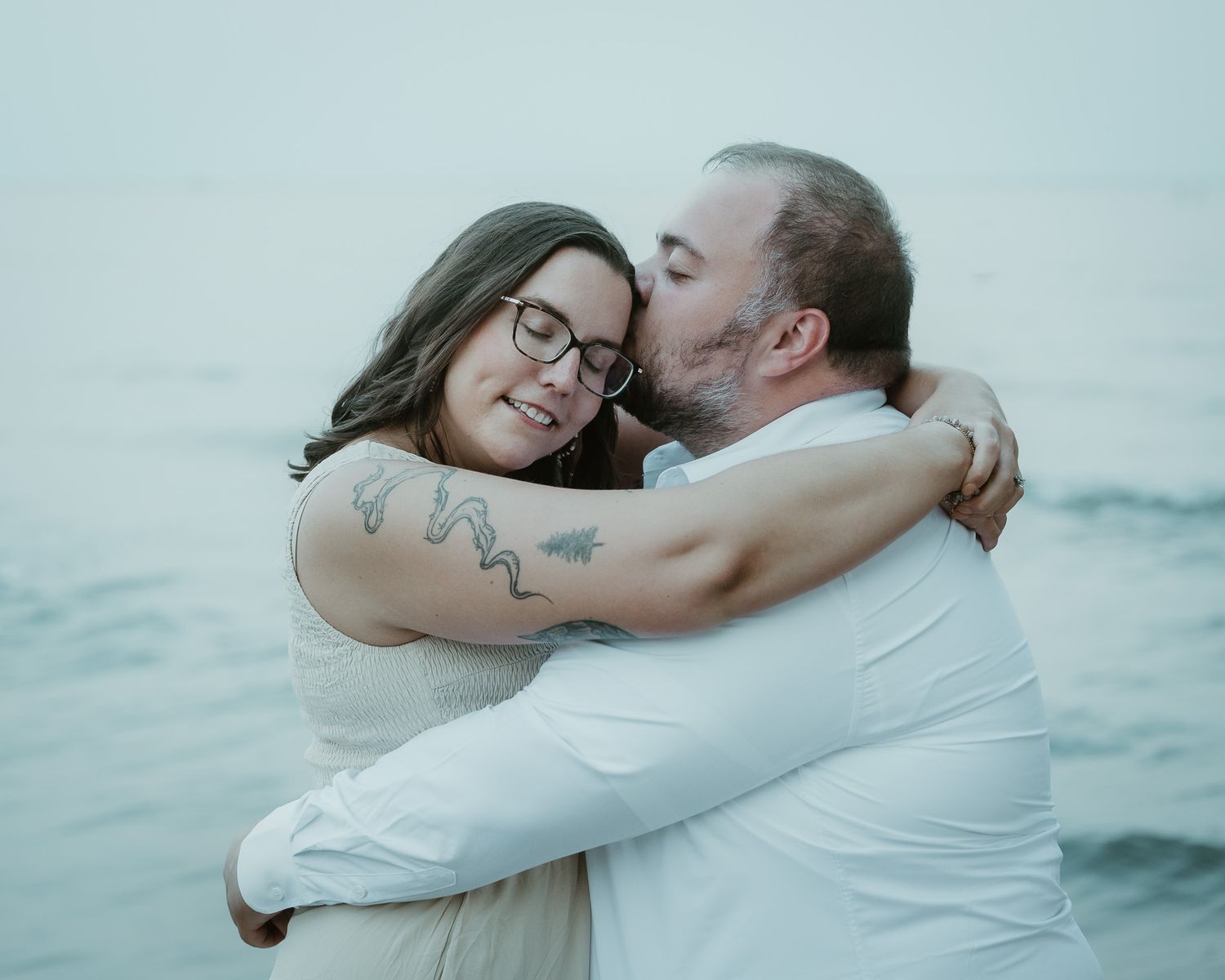 Couple hugging by the ocean, Connecticut engagement session