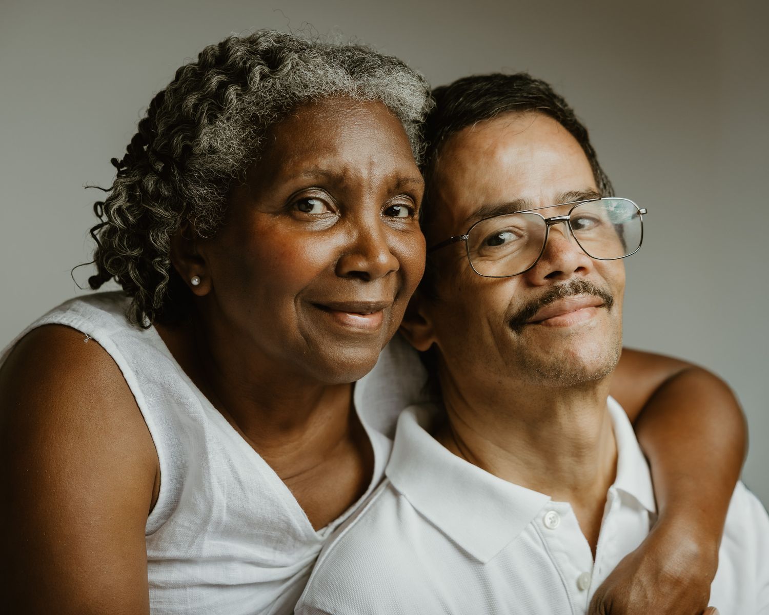 Husband and wife in close embrace, warm studio portrait, Woodbridge CT family photographer