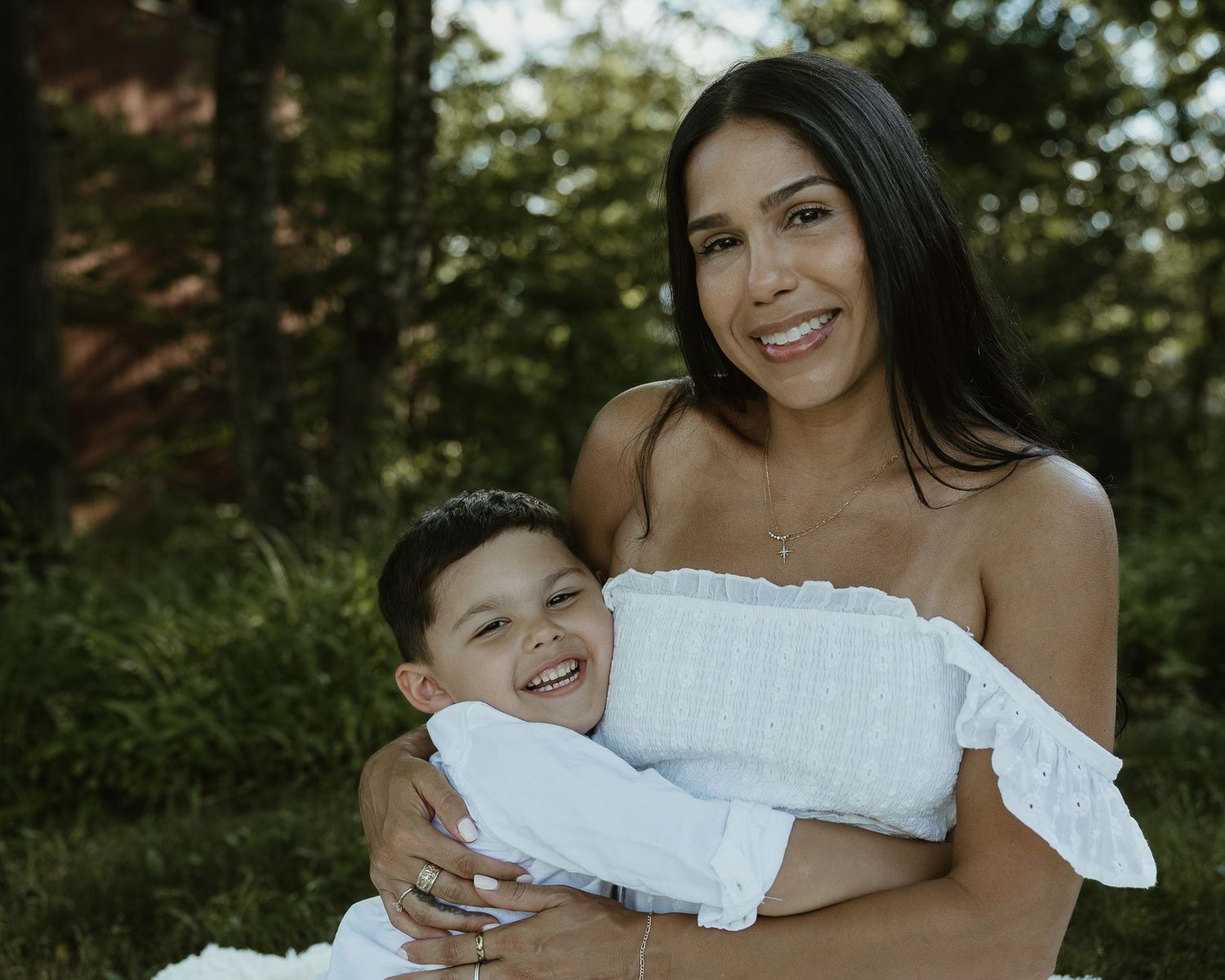 Woman holding a laughing child outdoors, Connecticut family photography session