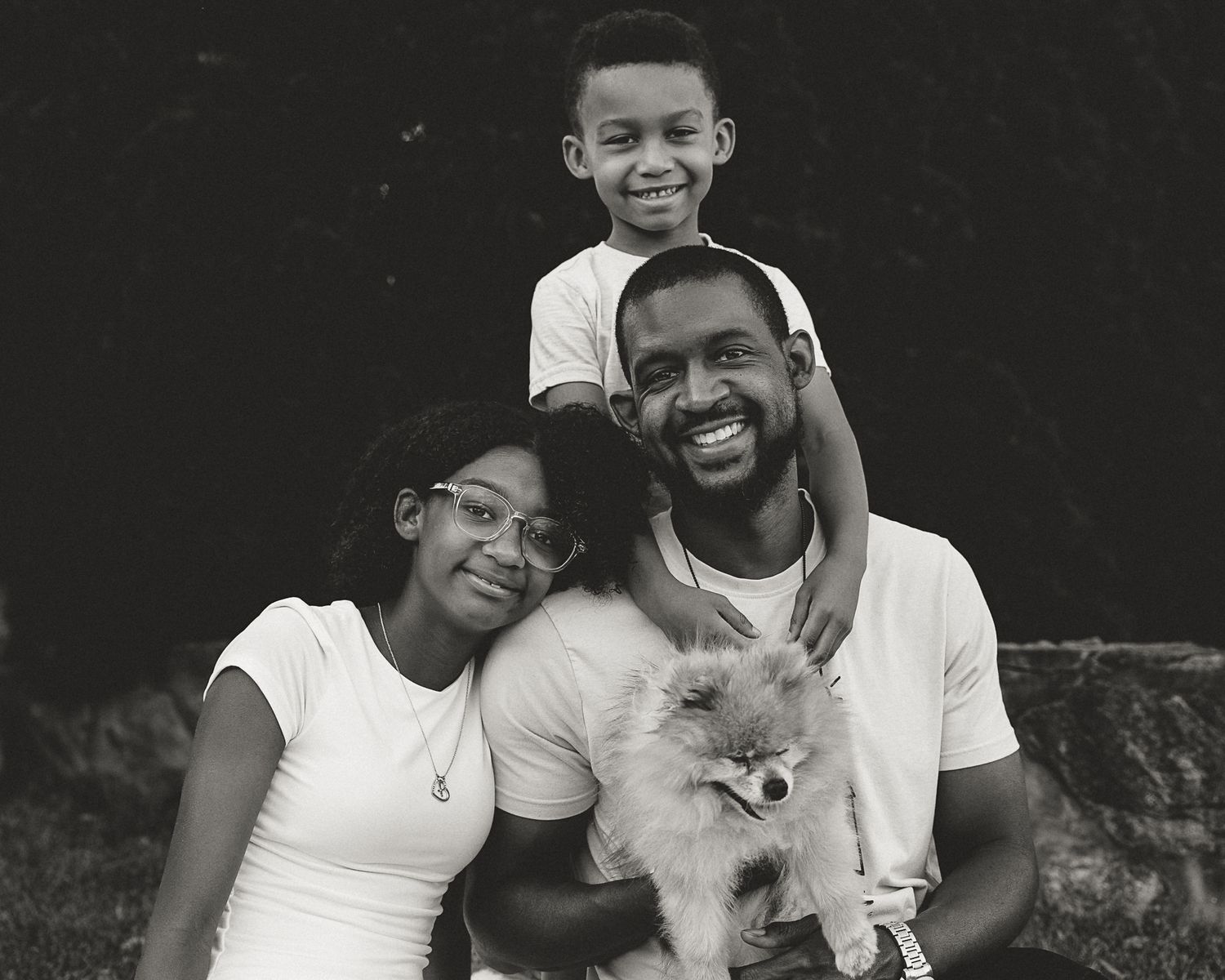 Black and white family portrait of four with their Pomeranian, Connecticut family portrait session