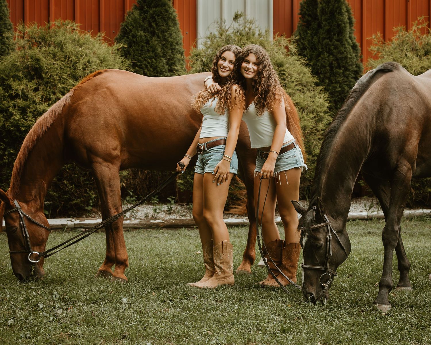 Twin sisters posing with their horses during an equestrian portrait session in Connecticut.
