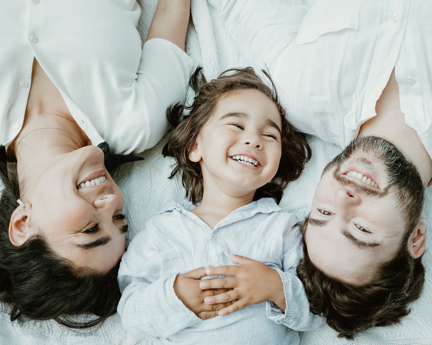 Family lying down together laughing, overhead portrait shot in Woodbridge, CT