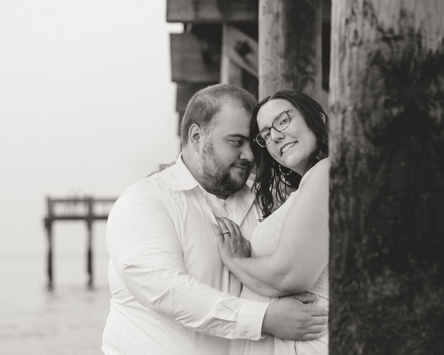 Black and white engagement portrait by the pier, Milford CT