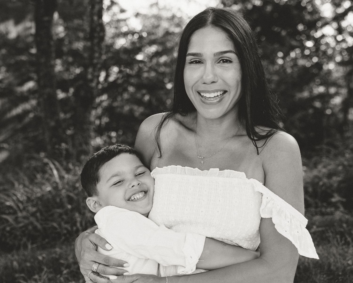 Black and white portrait of mother holding her laughing son outdoors, Connecticut family photography