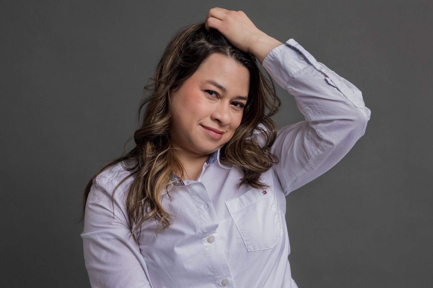 Professional studio portrait series showing elegant poses in a white button-down shirt against a gray backdrop.