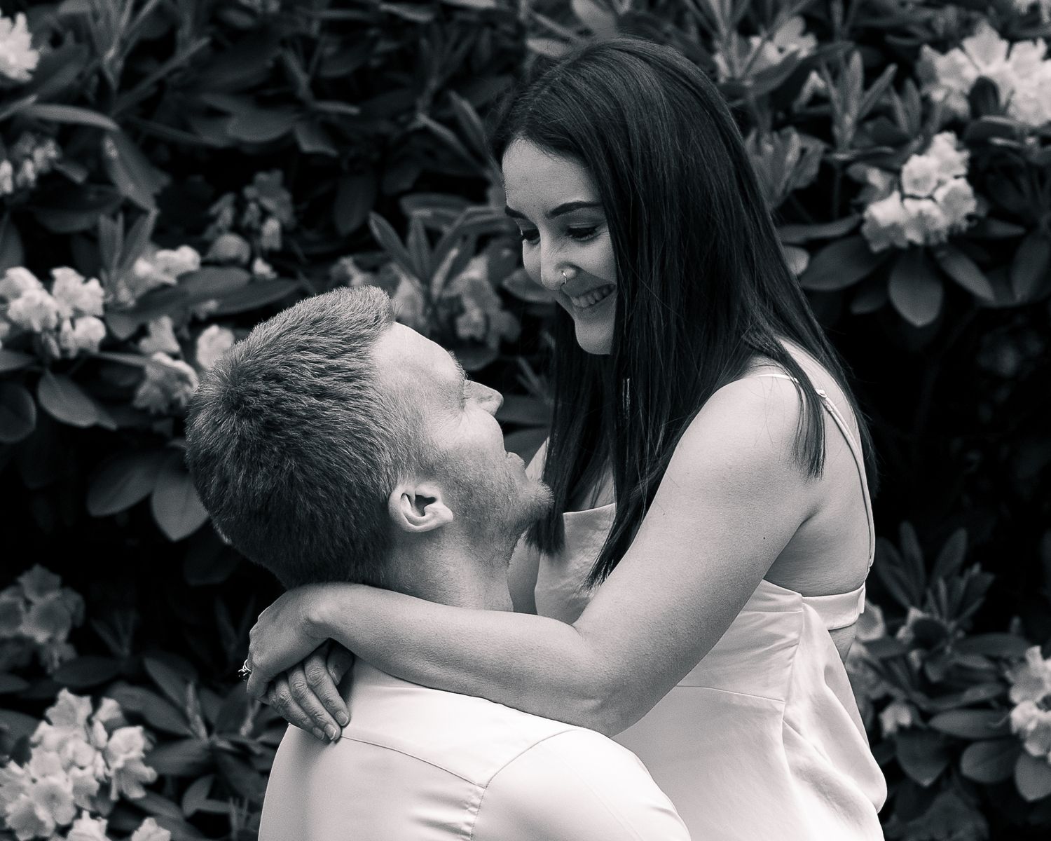 Couple almost kissing in rhododendron blooms, New Haven County CT portrait photographer