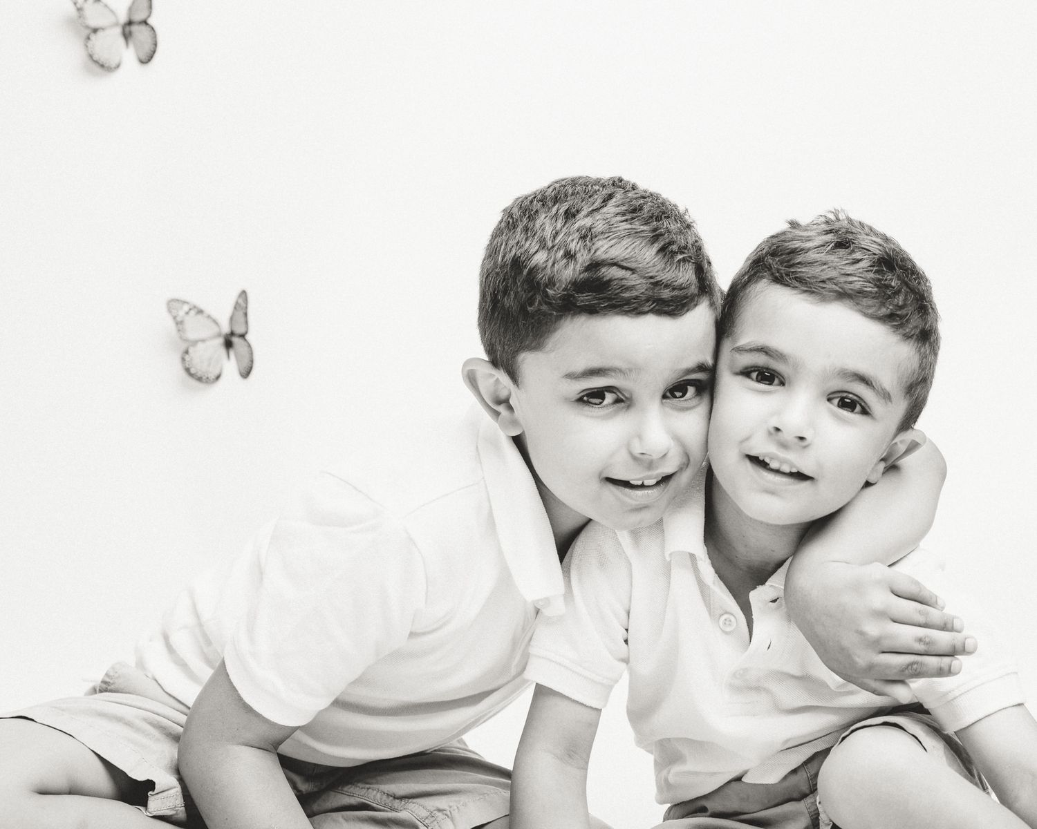 Two brothers embracing in studio butterfly session, Connecticut children's photography