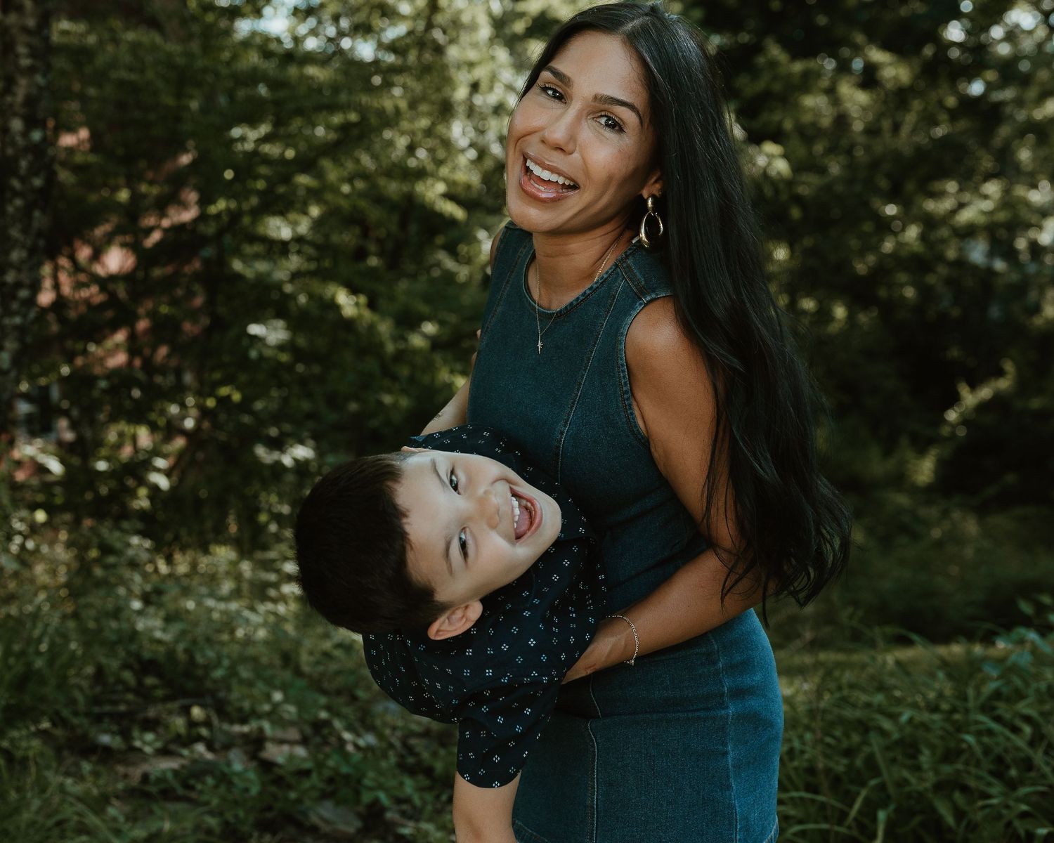 Mother holding her laughing son outdoors, Connecticut family photography session