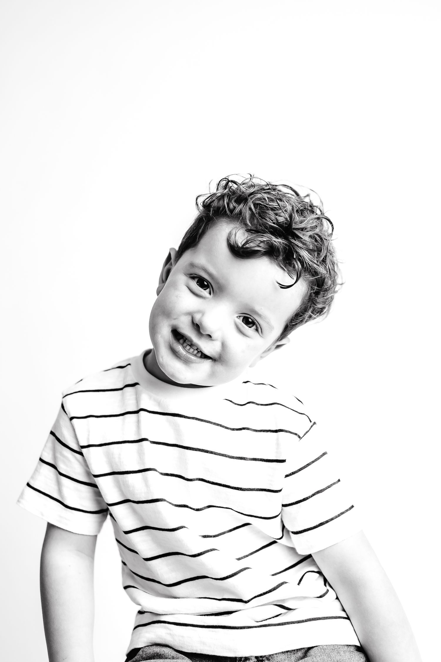 A sequence of black and white photos showing happy expressions in a striped shirt.