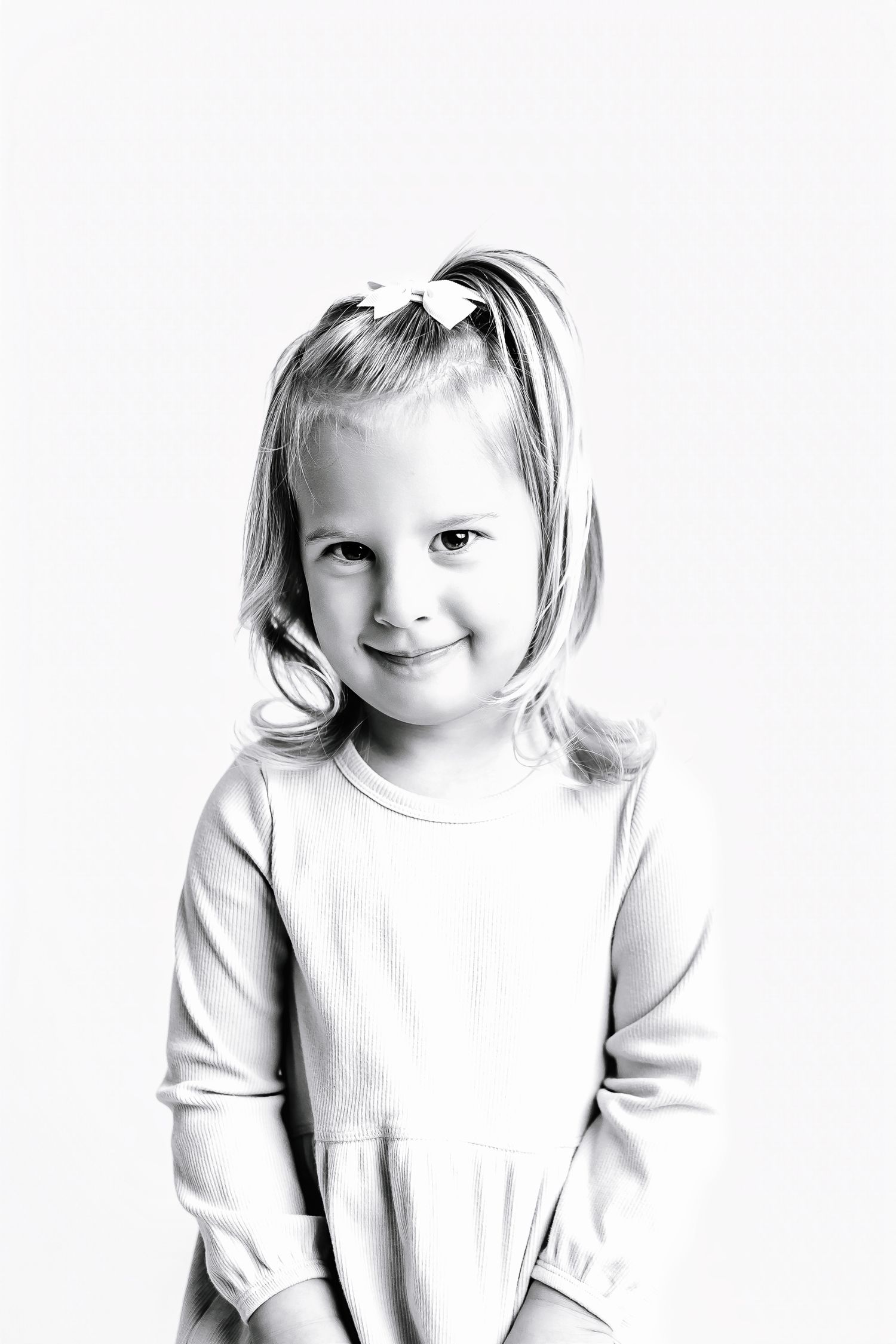 Series of black and white portraits showing sweet expressions in white clothing.