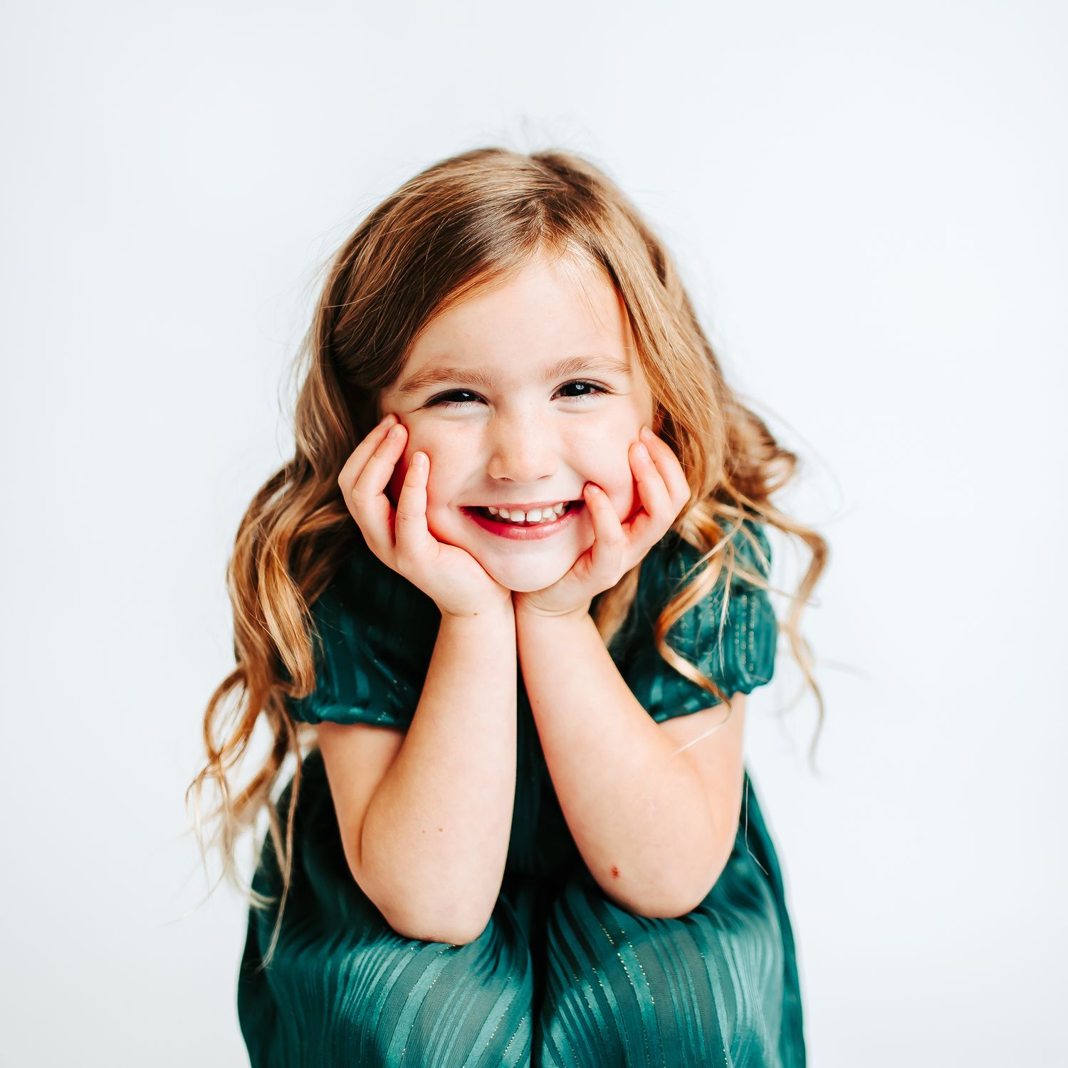 A series of playful expressions in a teal dress against a white background.