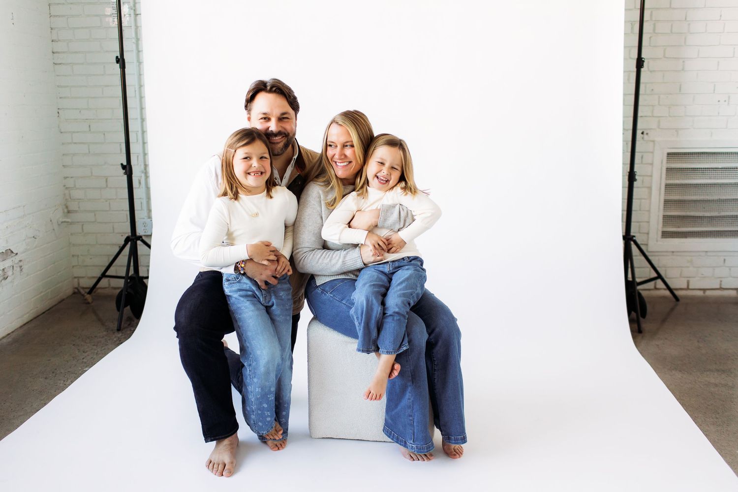 Studio family portraits against white backdrop showing natural interactions.