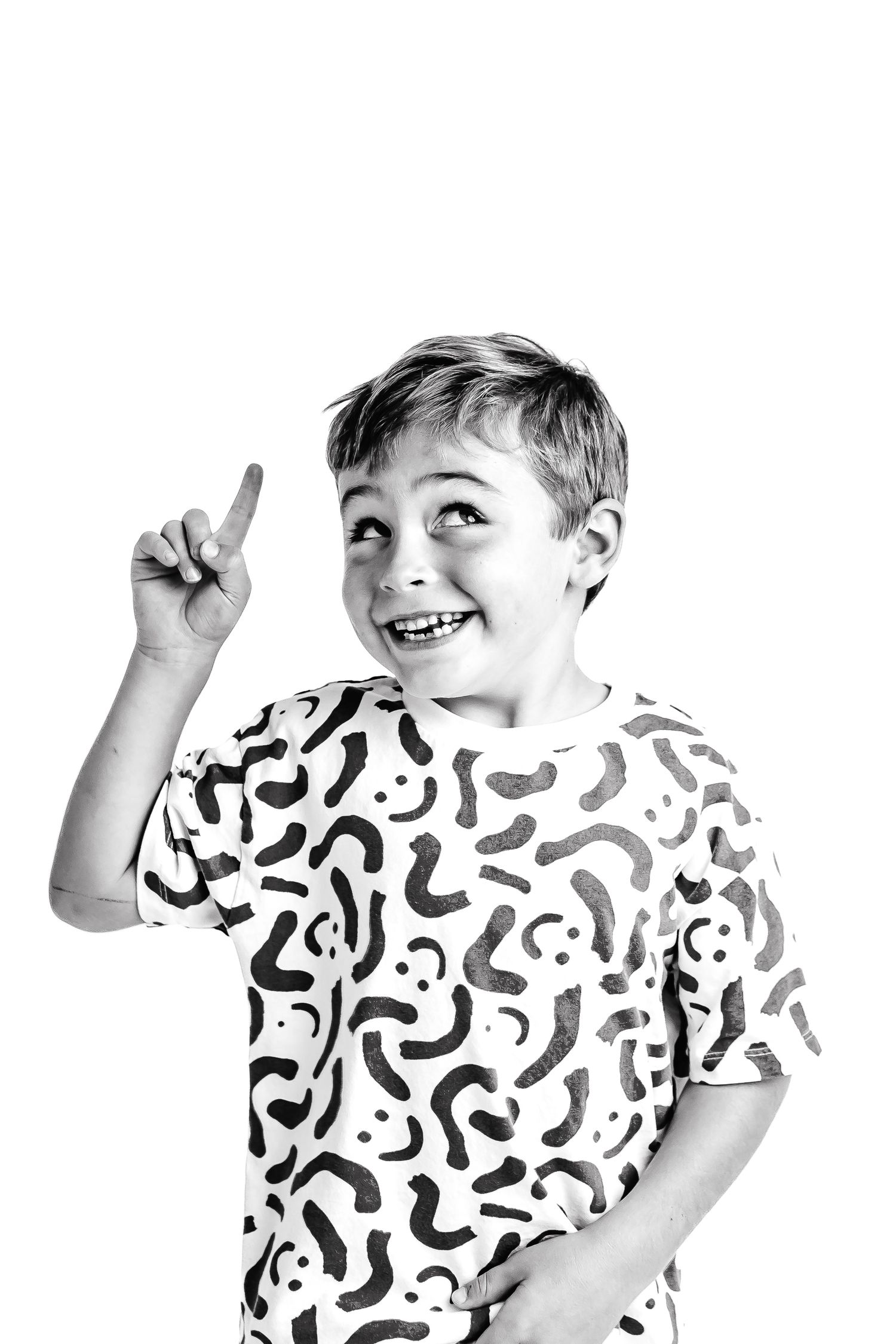 Multiple shots of a child dancing and posing in a white t-shirt with green abstract patterns.