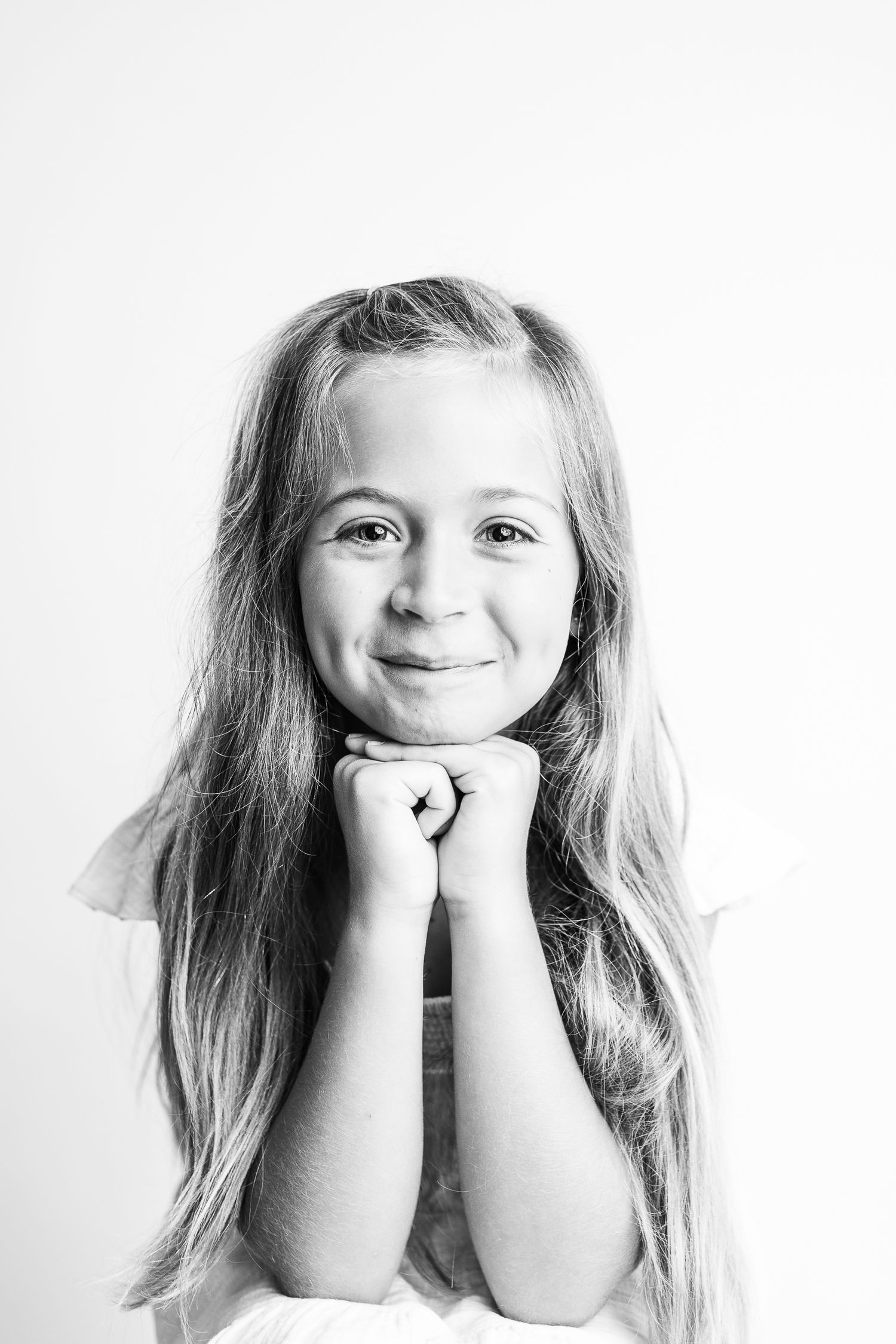 Black and white portrait series showing cheerful expressions and poses.