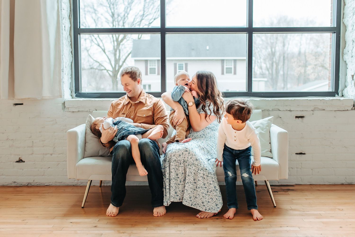Casual family lifestyle session in bright studio with large windows.