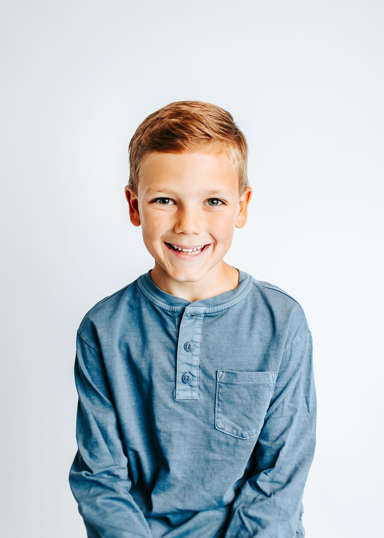 Multiple poses in a casual blue henley shirt against a white background.