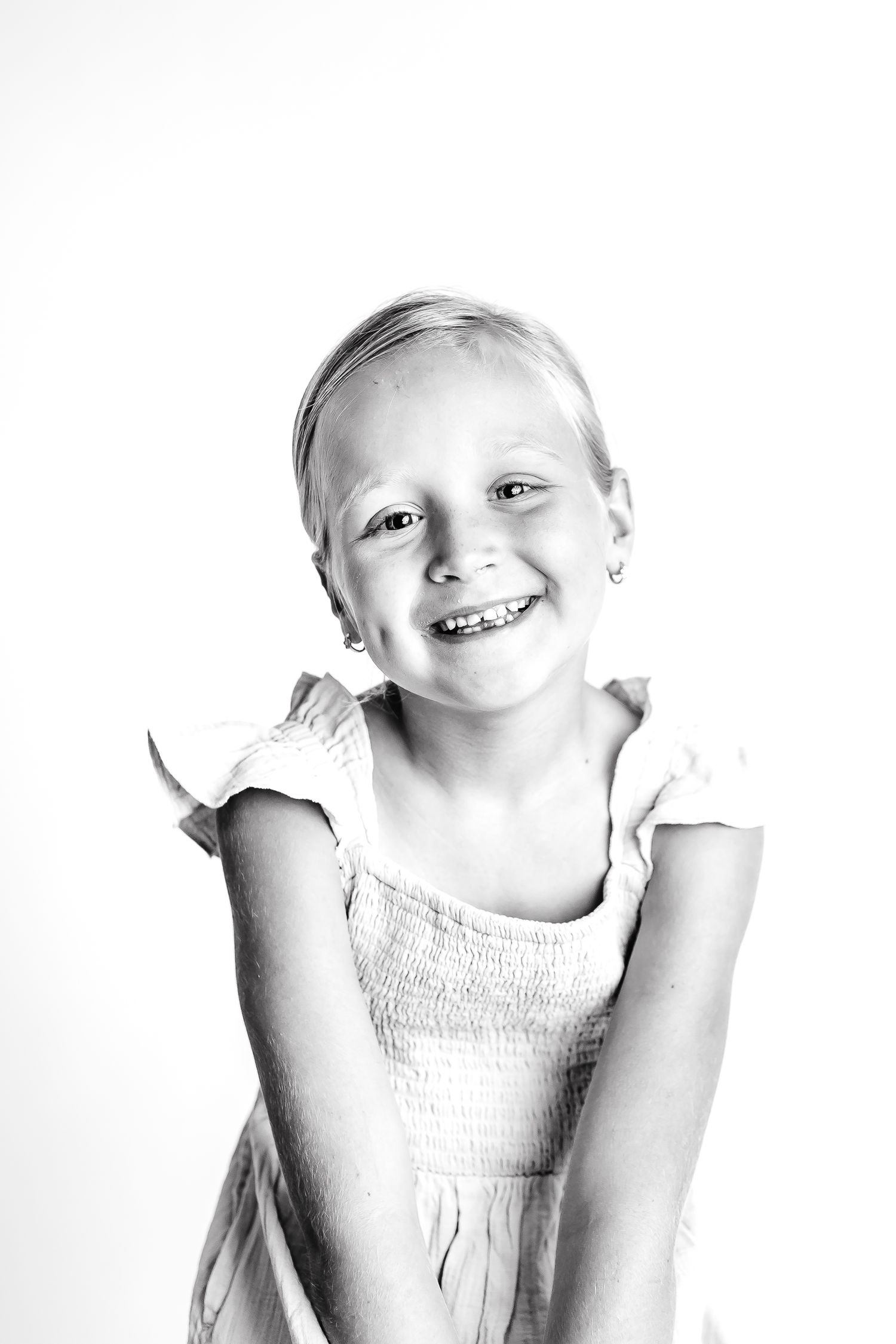 High key portraits showing bright smiles and playful expressions.
