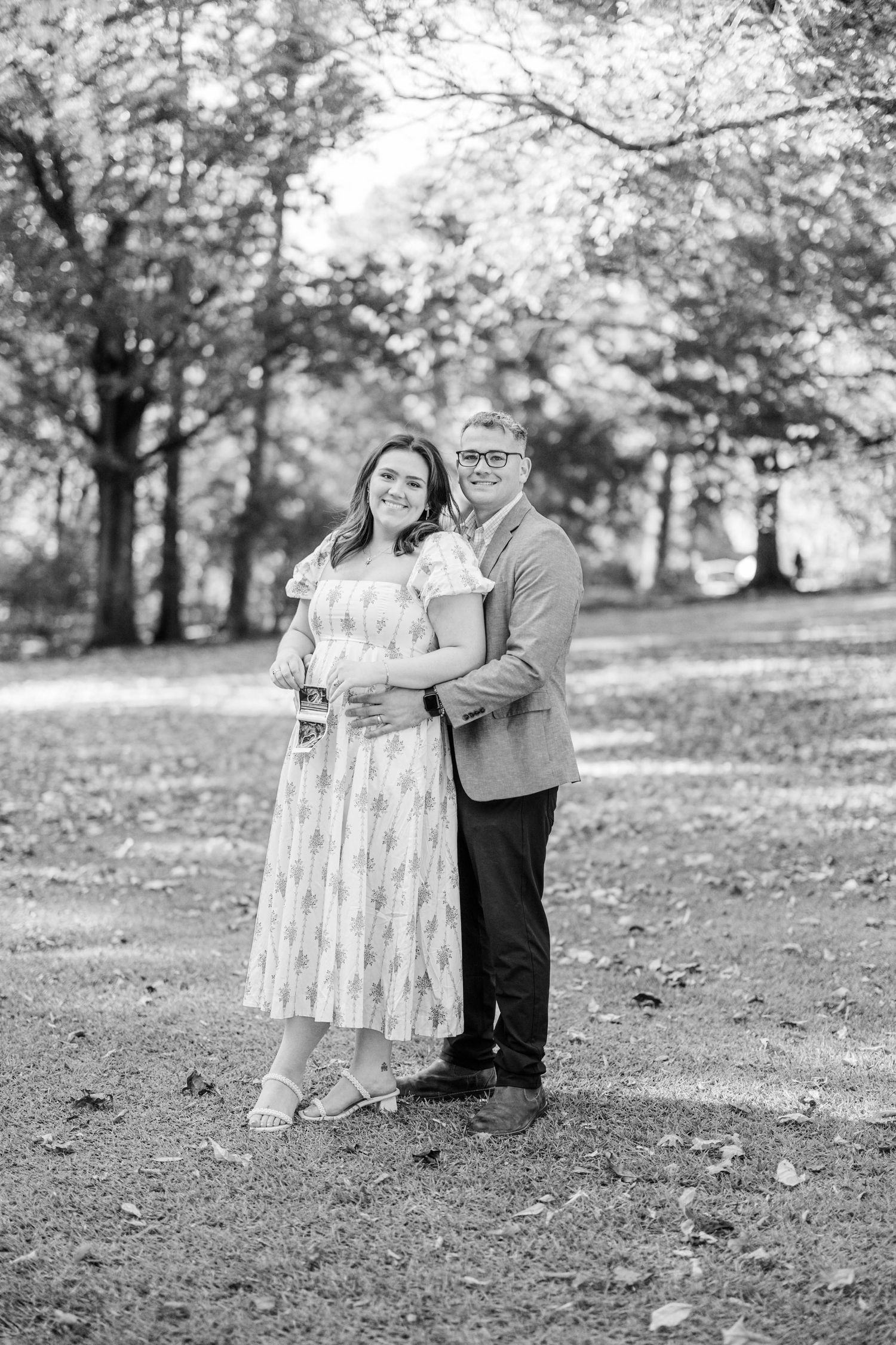 Black and white portrait of a couple in a fall setting.