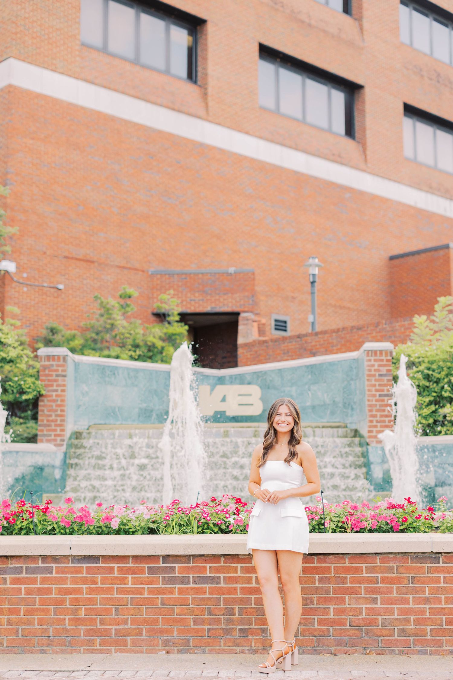 A series of photos near a brick building with fountains and landscaping.
